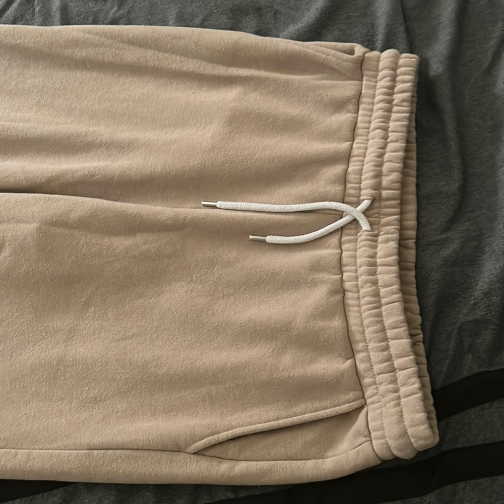 Light tanned sweat pants,slightly snug your body. Soft durable material